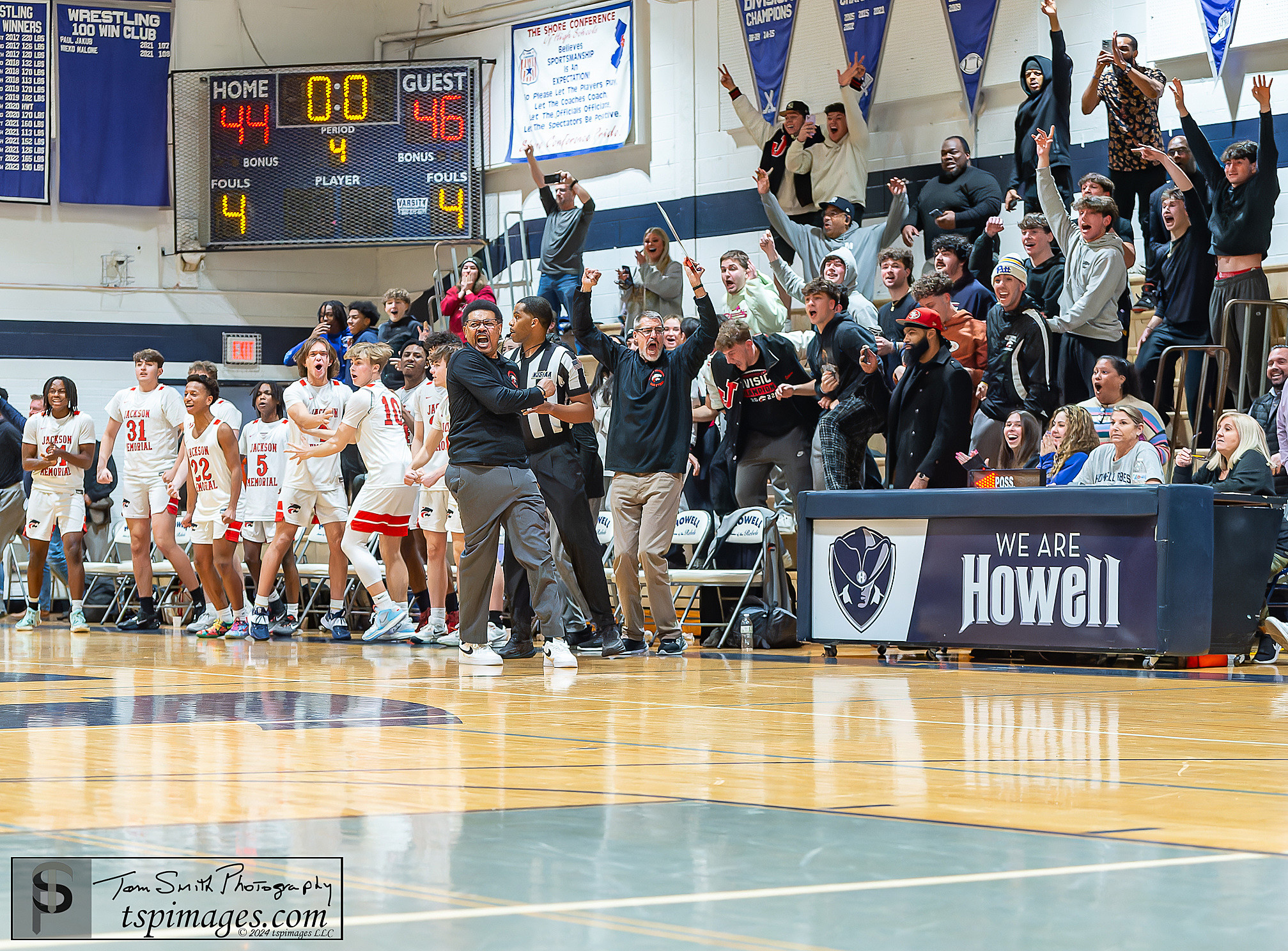 Jackson Memorial coach Randy Holmes and his team react to Brady Adams's winning shot as time expired in Wednesday's NJSIAA Central Group IV first-round game at Howell. (Photo: Tom Smith | tspsportsimages.com)